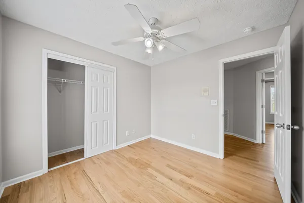 a view of an empty room with wooden floor