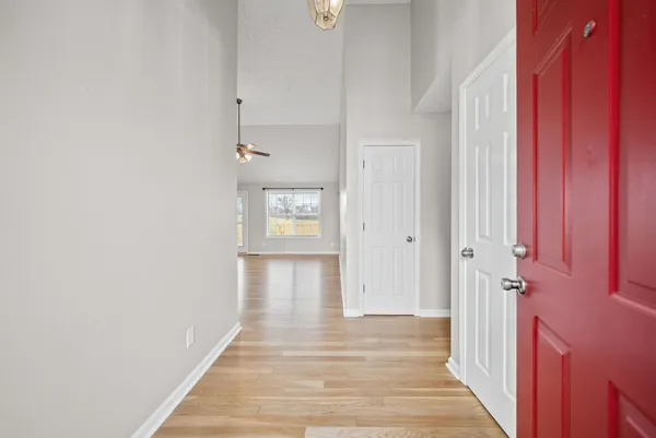 a view of a hallway with wooden floor and staircase