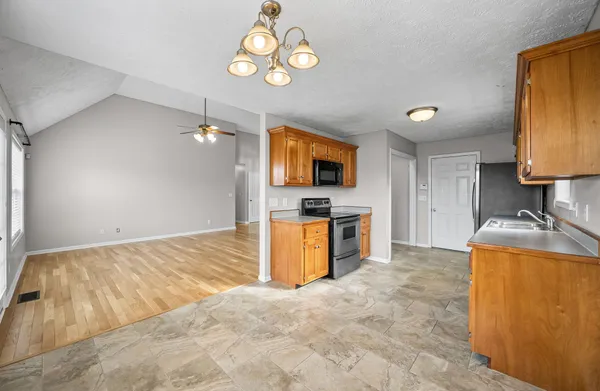 a kitchen with a stove a sink and a refrigerator
