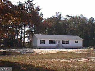 a view of house with outdoor space and trees