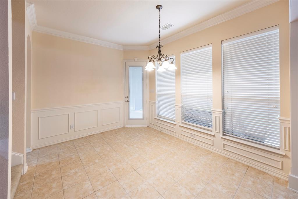 220 Justin Road Murphy, TX 75094 - Photo 16 of 40 Spare room featuring a chandelier, crown molding, and light tile patterned flooring