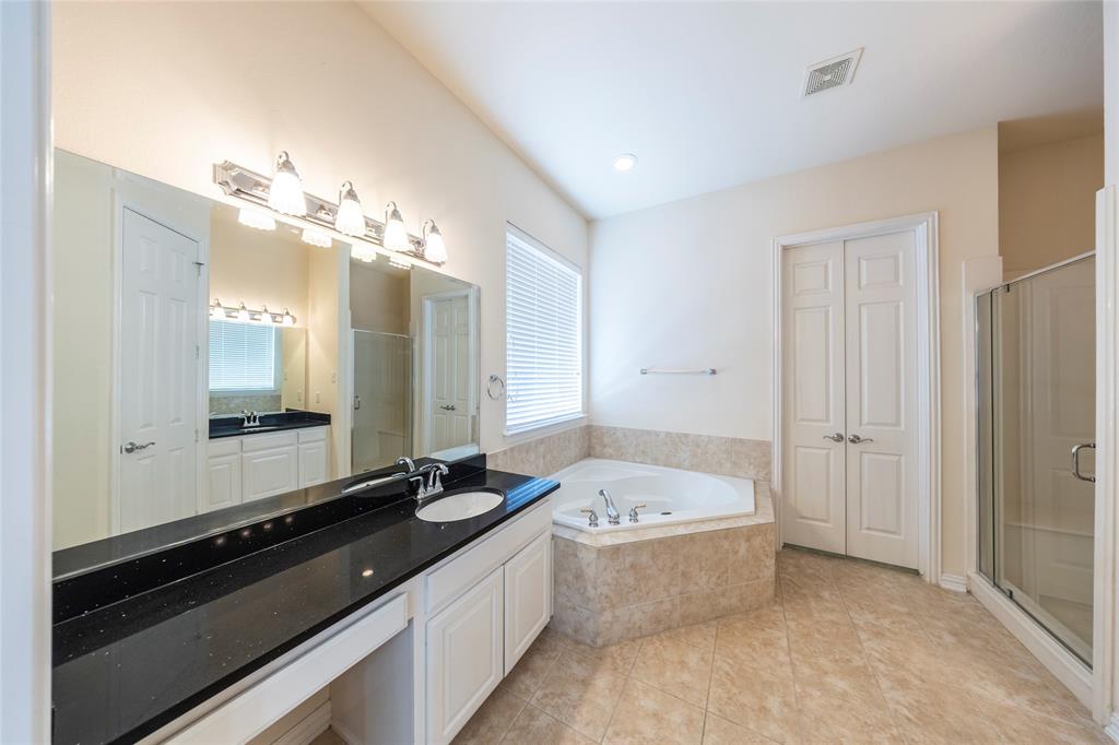 220 Justin Road Murphy, TX 75094 - Photo 18 of 40 Full bathroom with a bath, vanity, a shower stall, and tile patterned floors