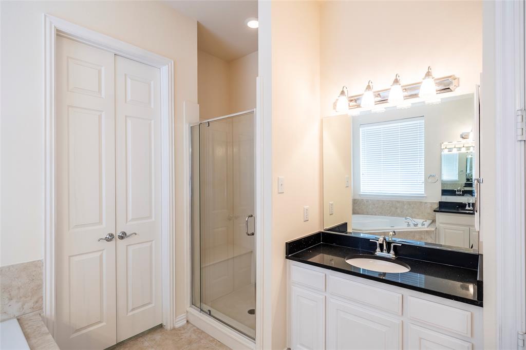 220 Justin Road Murphy, TX 75094 - Photo 19 of 40 Full bath with a shower stall, vanity, a garden tub, and tile patterned floors