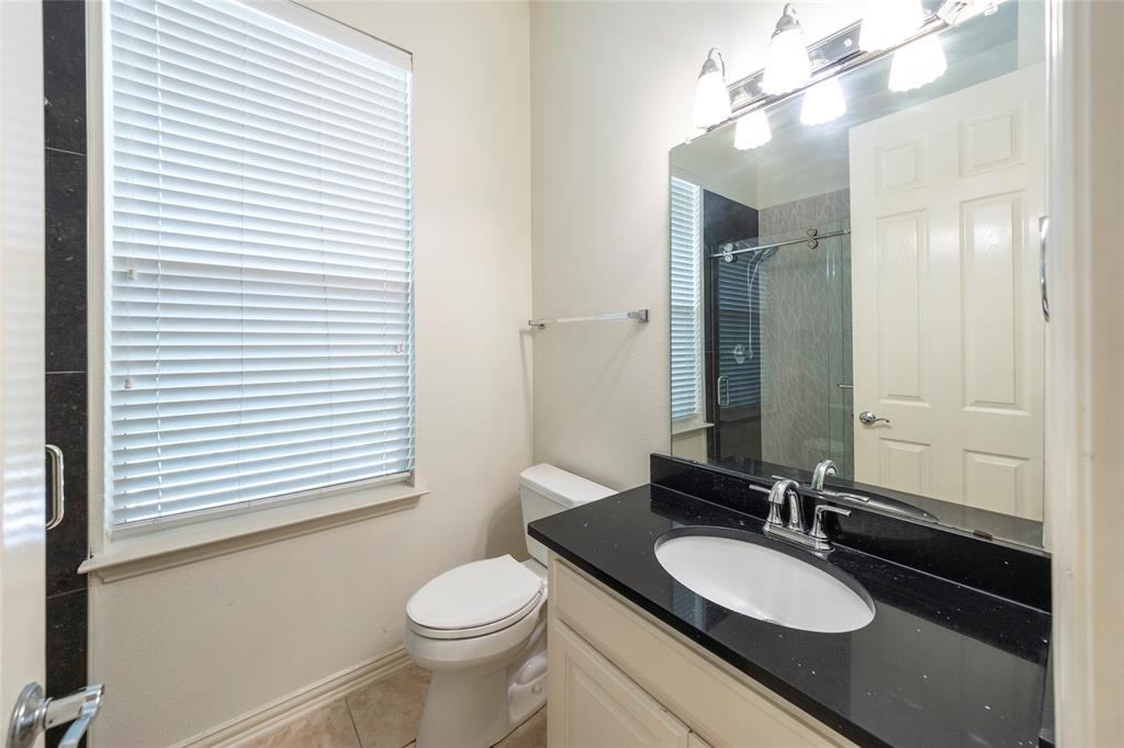 220 Justin Road Murphy, TX 75094 - Photo 22 of 40 Bathroom featuring an enclosed shower, toilet, vanity, and tile patterned floors