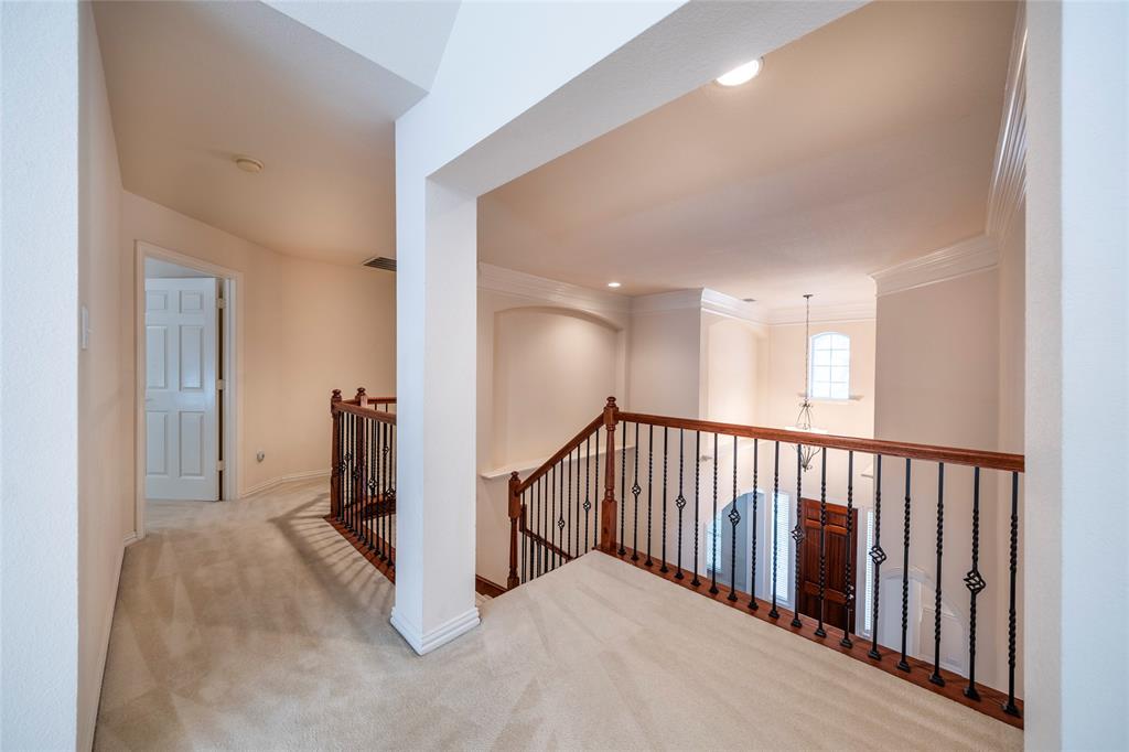 220 Justin Road Murphy, TX 75094 - Photo 24 of 40 Hallway with an upstairs landing, carpet flooring, crown molding, baseboards, and recessed lighting