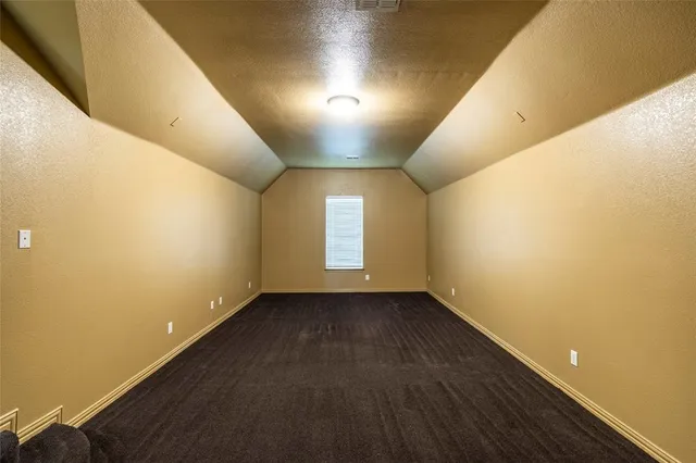 an empty room with closet and windows