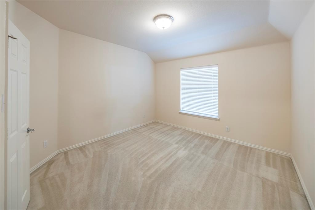 220 Justin Road Murphy, TX 75094 - Photo 29 of 40 Unfurnished room featuring light carpet, baseboards, and vaulted ceiling