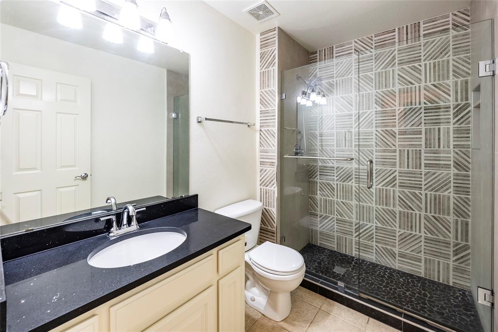 220 Justin Road Murphy, TX 75094 - Photo 30 of 40 Full bath featuring a stall shower, toilet, vanity, and tile patterned flooring