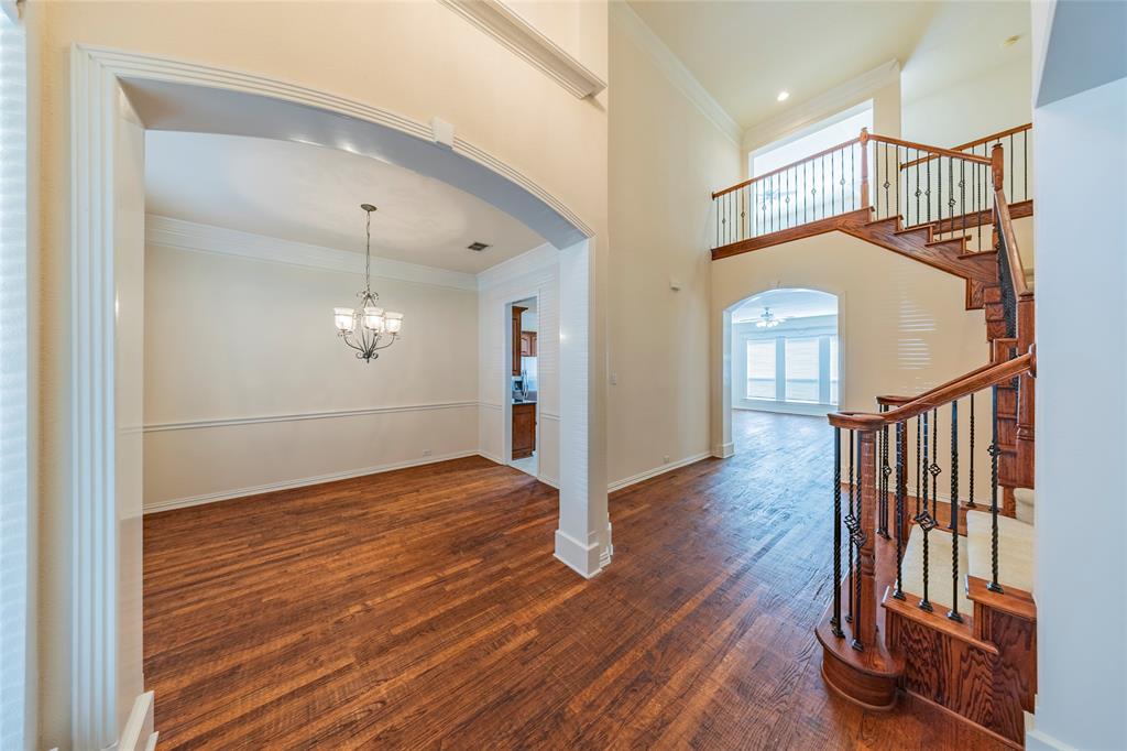 220 Justin Road Murphy, TX 75094 - Photo 4 of 40 Foyer with arched walkways, ornamental molding, stairs, wood finished floors, and a chandelier