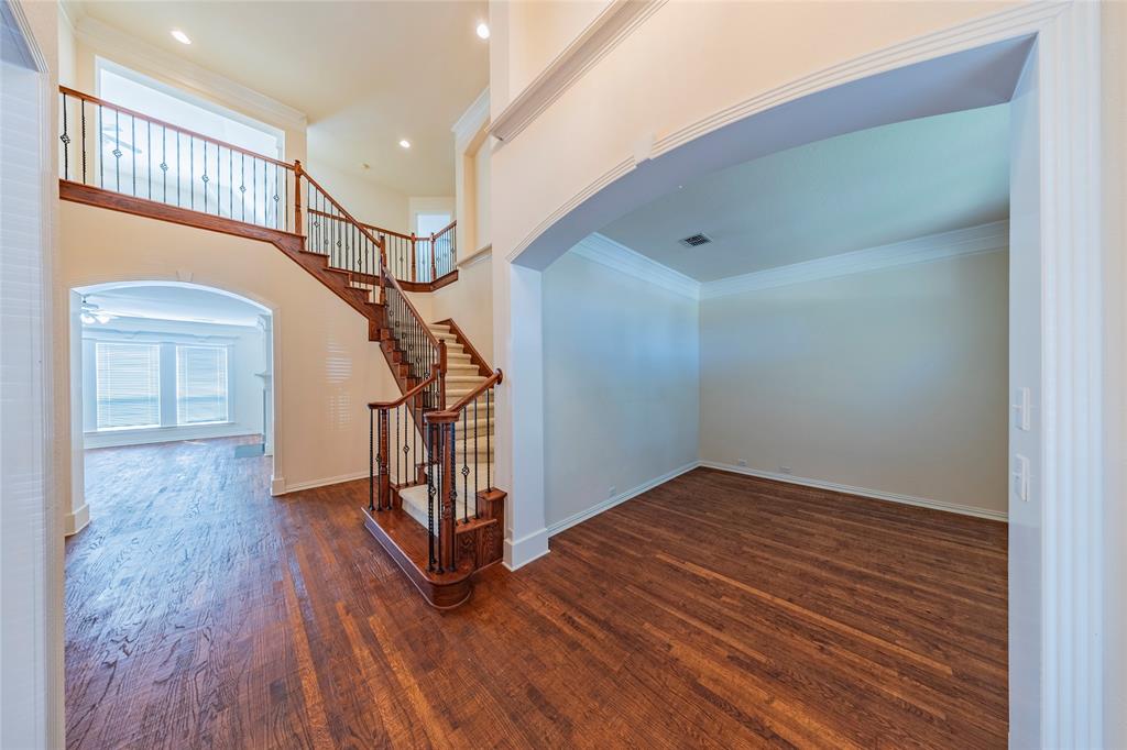 220 Justin Road Murphy, TX 75094 - Photo 5 of 40 Stairs with arched walkways, wood finished floors, plenty of natural light, ornamental molding, and recessed lighting