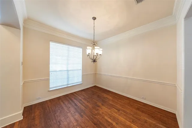 a view of a room with wooden floor and white walls