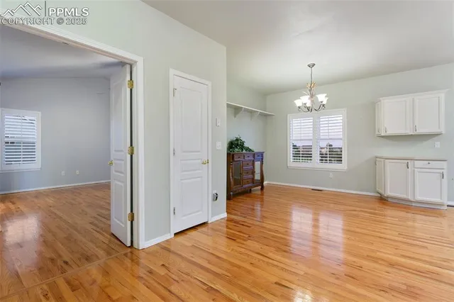 a kitchen with stainless steel appliances a stove a microwave and white cabinets