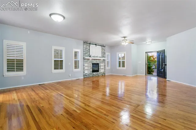 a view of empty room with wooden floor