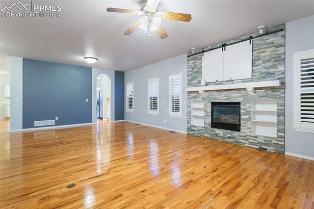 a view of empty room with wooden floor