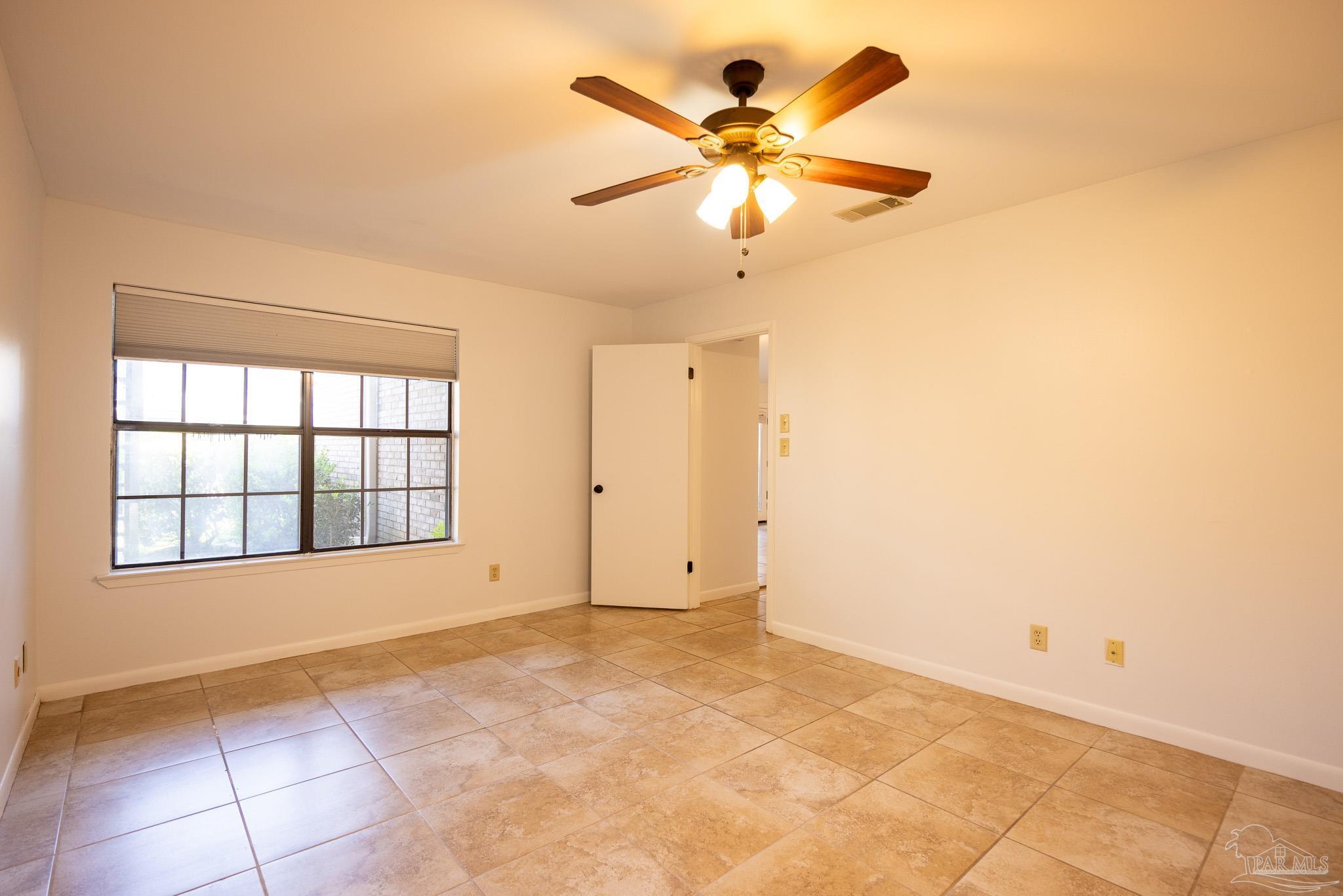 7150 Plantation Road, Unit 312 Pensacola, FL 32504 - Photo 9 of 14 a view of an empty room with a window