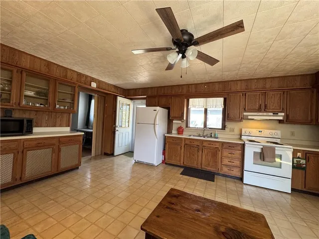 a kitchen with a stove a sink and a refrigerator