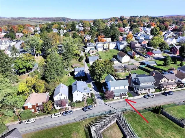 an aerial view of multiple houses with yard