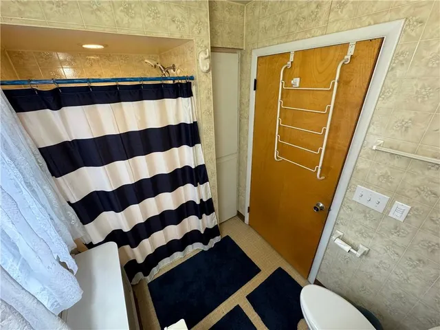 a bathroom with a black and white checkered floor