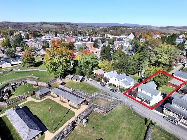 an aerial view of a houses with a yard