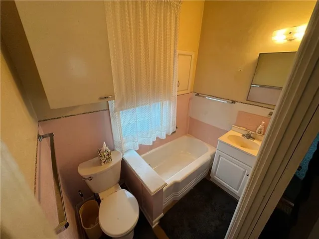 a bathroom with a sink toilet and tub