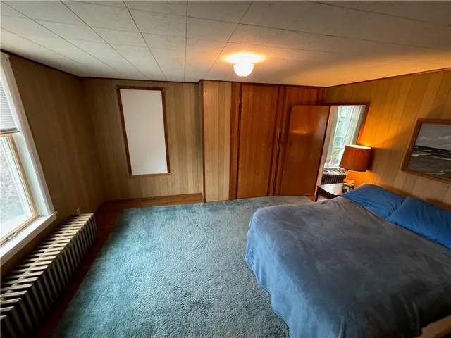 a bed room with a bed and a window
