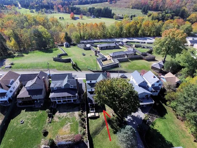 an aerial view of a house with yard swimming pool and outdoor seating