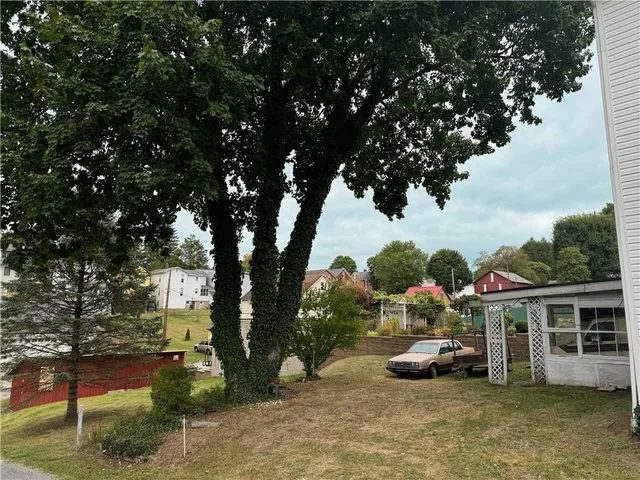 a view of a house with backyard porch and sitting area