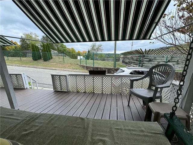 a view of balcony with wooden floor and outdoor seating