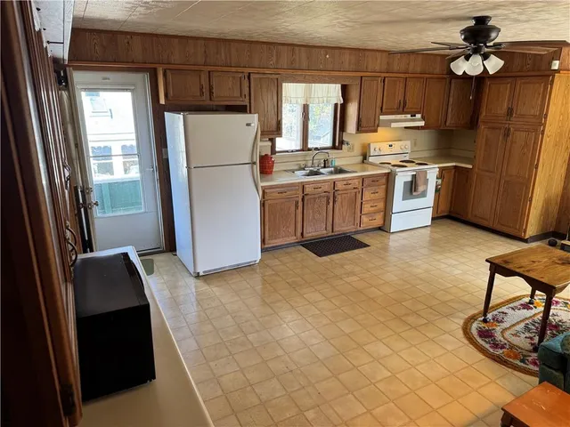 a kitchen with stainless steel appliances a refrigerator sink and cabinets
