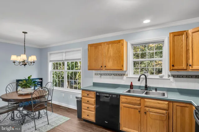 a kitchen with stainless steel appliances granite countertop a sink stove refrigerator and a window