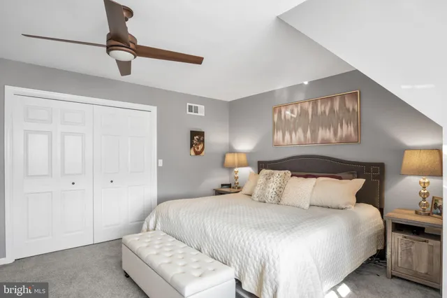a living room with furniture and a book shelf