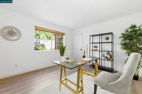 a view of a workspace with furniture and a window