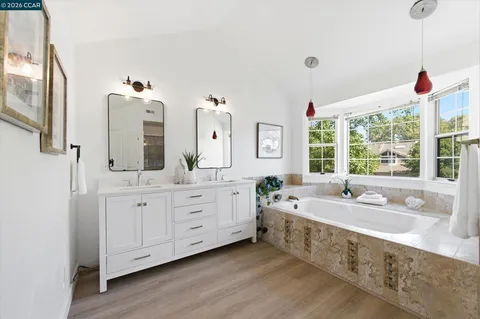 a bath room with double vanity sink and a mirror