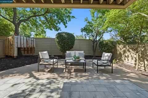 a view of a chairs and table in backyard