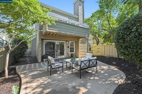a view of a house with backyard and sitting area