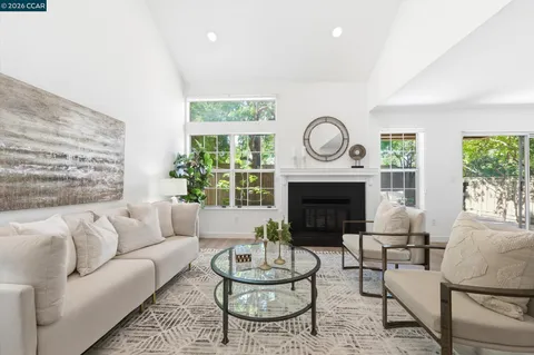 a living room with furniture a window and a fireplace