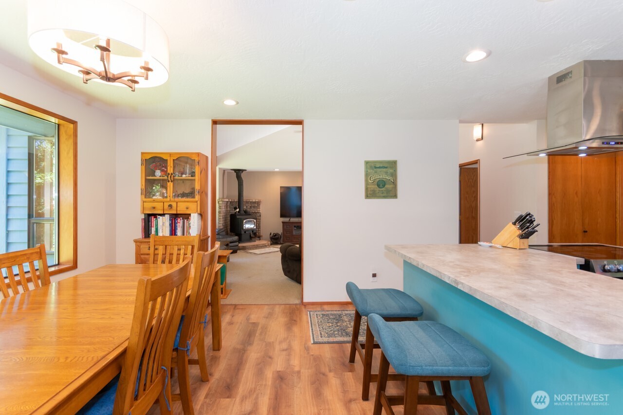 492 Walkabout Way Port Angeles, WA 98363 - Photo 14 of 40 a view of a dining room with furniture and a flat screen tv