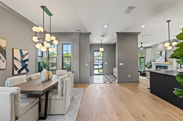 a living room with furniture fireplace and a large window