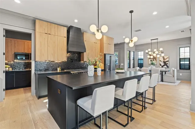 a kitchen with a sink a stove and chairs