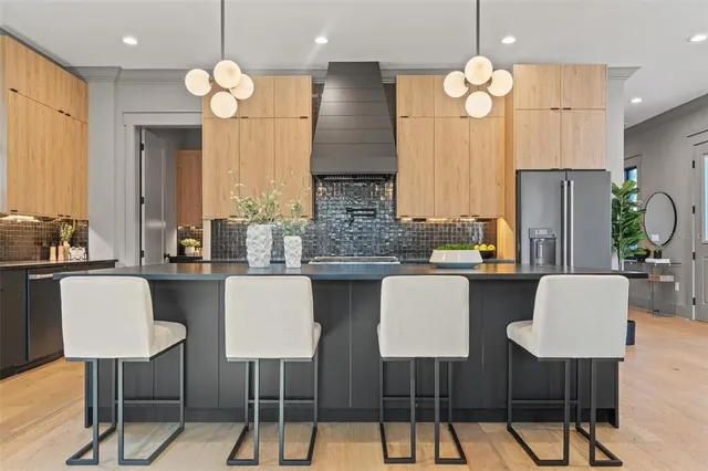 a kitchen with stainless steel appliances granite countertop a stove a sink and a microwave