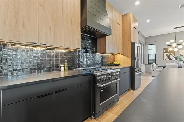a hallway with cabinets and wooden floor