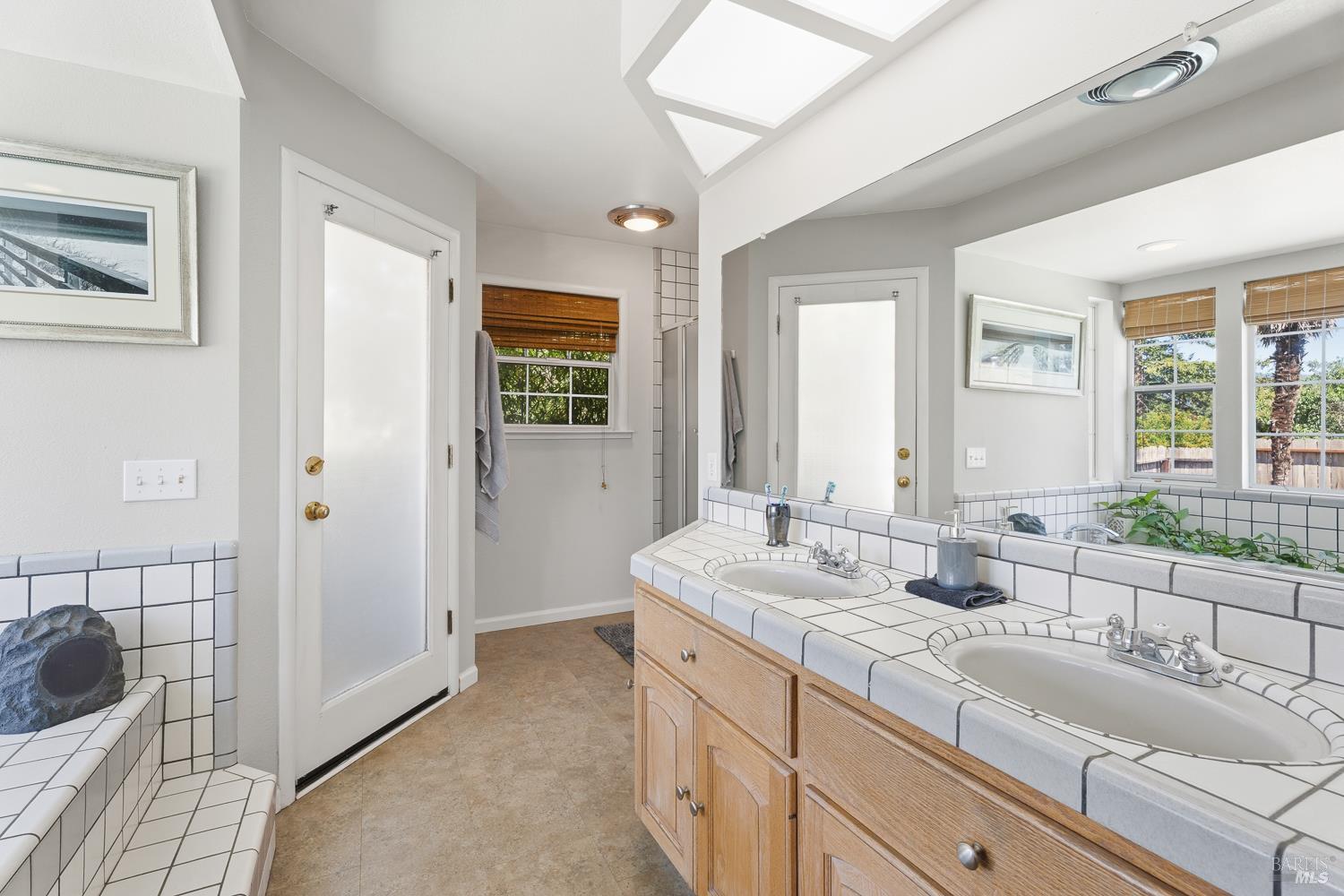 2260 Old River Road Ukiah, CA 95482 - Photo 19 of 29 a spacious bathroom with a double vanity sink a mirror and a shower