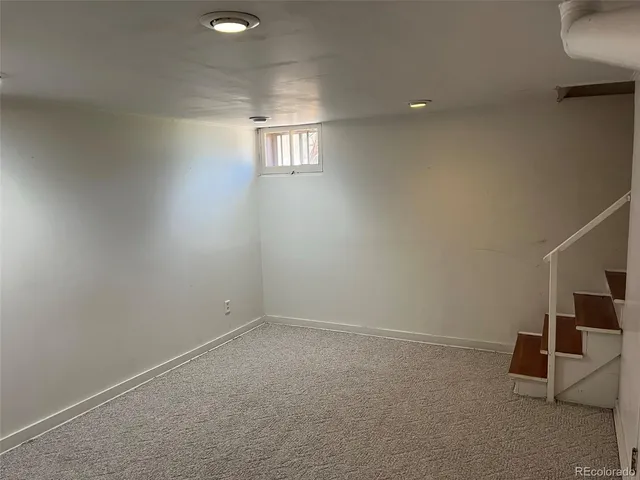 an empty room with windows and entrance
