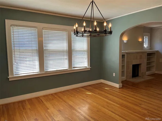 a view of a livingroom with a ceiling fan and window
