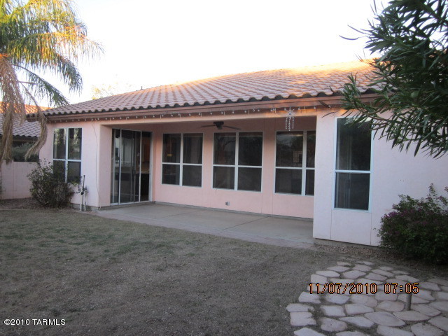 9920 North Stratton Saddle Trail Tucson, AZ 85742 - Photo 10 of 10 a view of a large house with a large window and plants