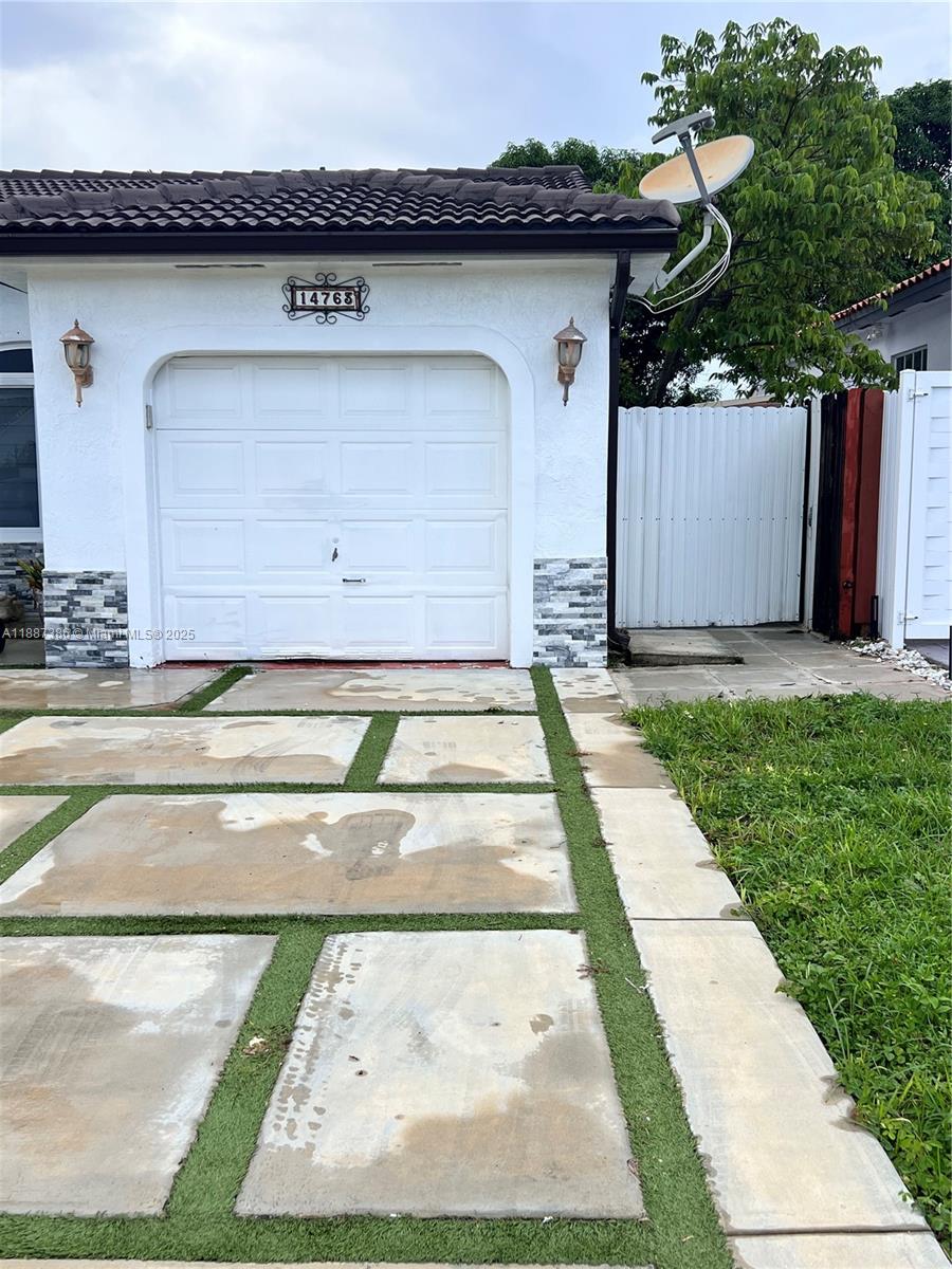 14763 Southwest 173rd Terrace Miami, FL 33187 - Photo 1 of 22 a view of a garage of the house