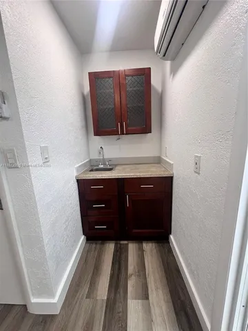 a room with a sink and a mirror