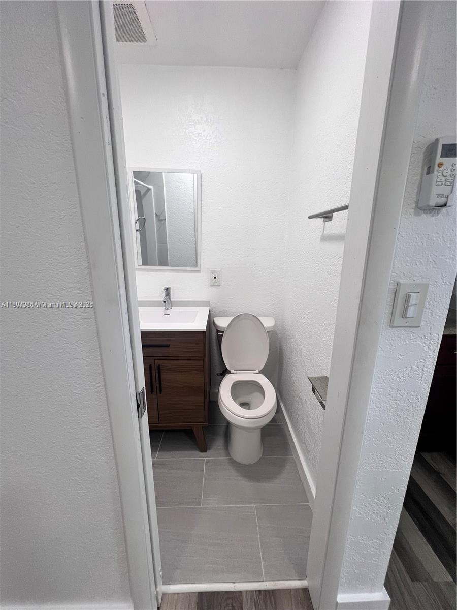 14763 Southwest 173rd Terrace Miami, FL 33187 - Photo 20 of 22 a bathroom with a toilet and a sink