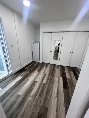a view of a closet area with furniture and wooden floor