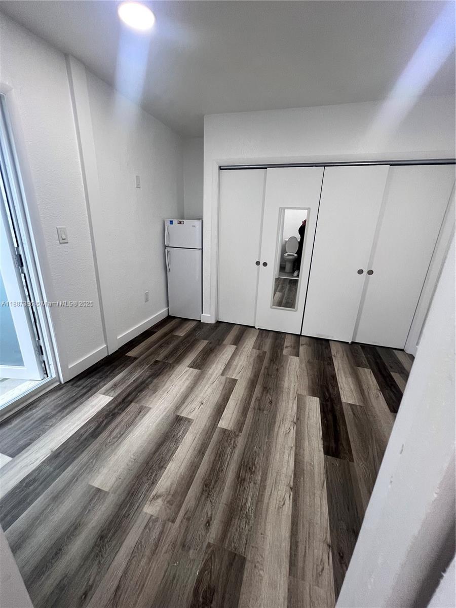 14763 Southwest 173rd Terrace Miami, FL 33187 - Photo 10 of 22 a view of a closet area with furniture and wooden floor